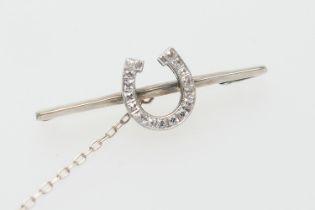 Diamond horse shoe bar brooch, in 9ct white gold, set with sixteen square cut diamonds, well matched