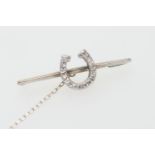 Diamond horse shoe bar brooch, in 9ct white gold, set with sixteen square cut diamonds, well matched