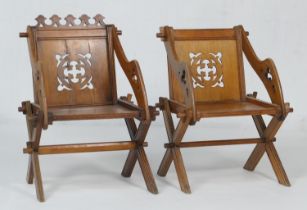 Pair of late Victorian or Edwardian oak Glastonbury type armchairs, with carved cresting rail (one
