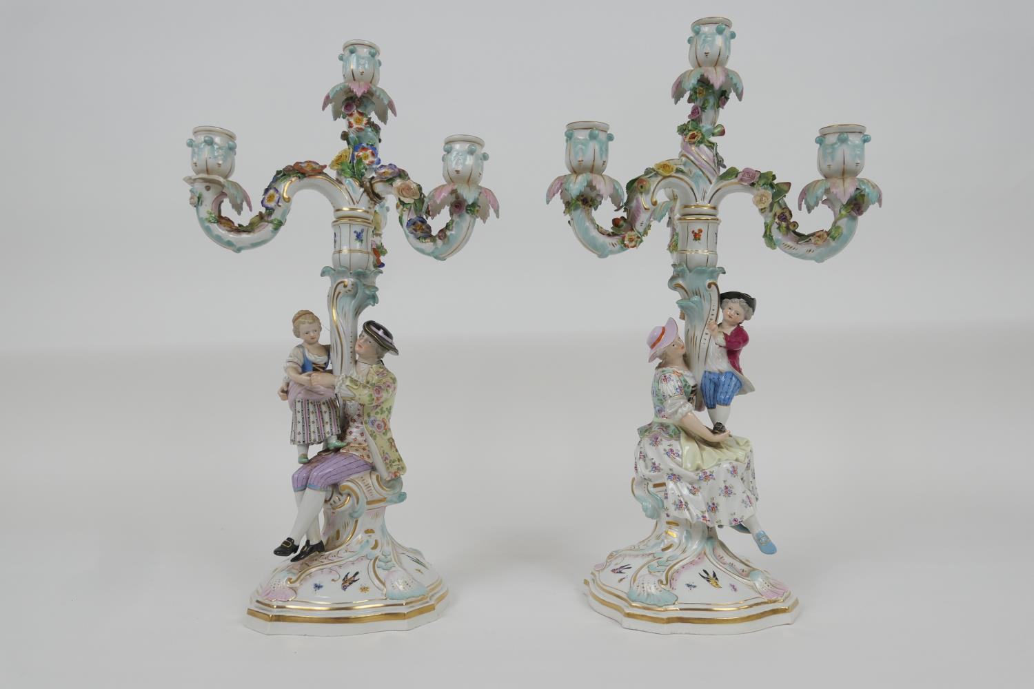 Pair of Meissen porcelain figural candelabra, 19th Century, each with three floral encrusted