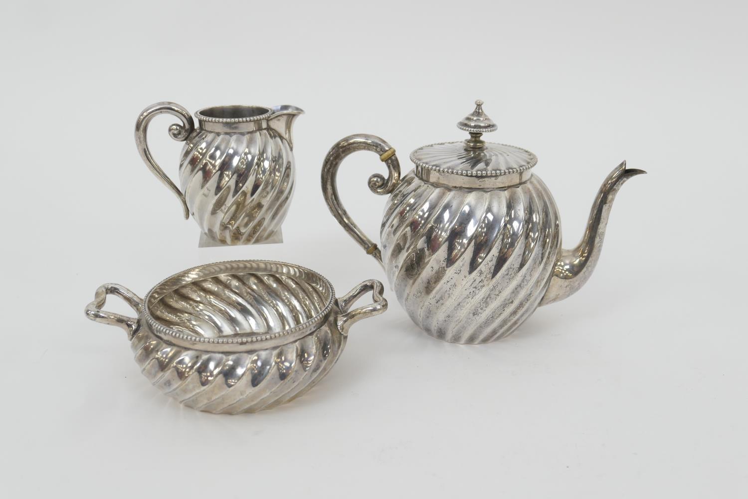 Dutch 833 standard silver three piece tea service, early 20th Century, comprising wrythen bullet