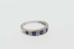 Synthetic sapphire and diamond half eternity ring, in 9ct white gold, the round cut stones channel