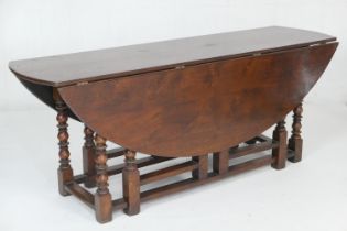 Quality large oak gateleg table in 18th Century style, the oval top with drop leaves supported on