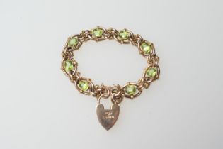 9ct gold peridot bracelet, open oval links centred with oval cut peridots, united by a safety
