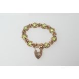 9ct gold peridot bracelet, open oval links centred with oval cut peridots, united by a safety