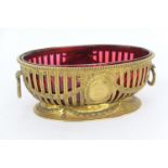 Martin Hall & Co. gilt metal table bowl in the Adam style, early 20th Century, oval form with red