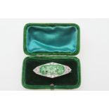 Art Deco carved jade and diamond brooch in 18ct gold and platinum, lozenge shape centred with a jade