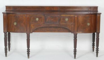 Early Victorian mahogany bowfront sideboard, circa 1840, with a stepped back over a frieze drawer