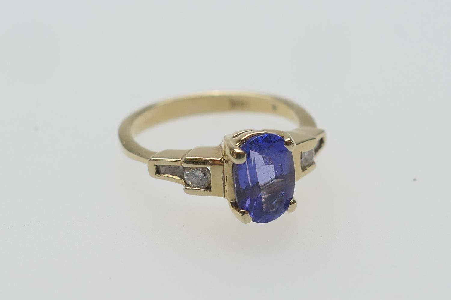 Continental tanzanite and diamond dress ring in 14ct gold, the oval cut tanzanite approx. 9mm x 6mm,