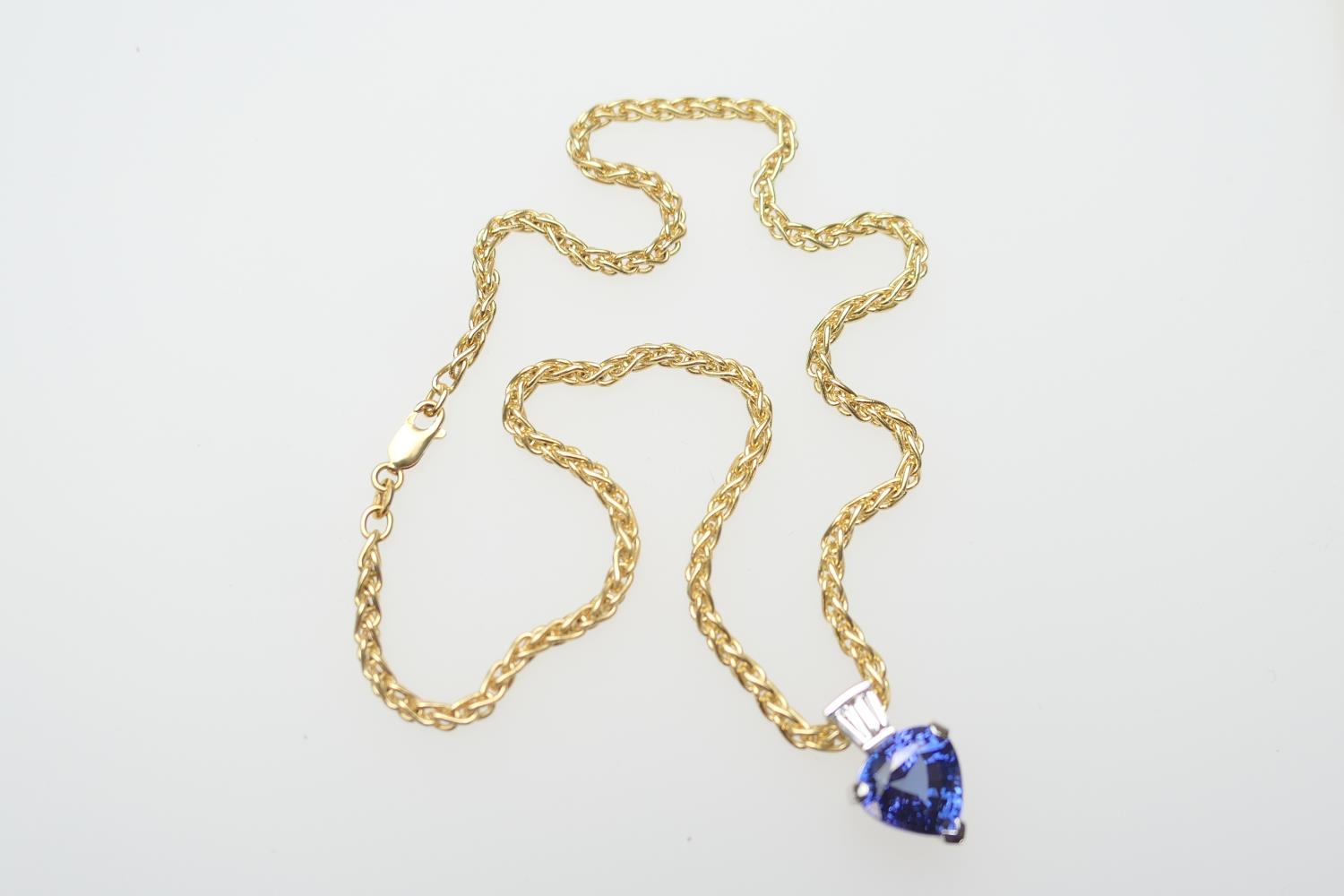 Tanzanite and diamond pendant necklace, in 18ct gold, the trilliant cut tanzanite approx. 10mm x