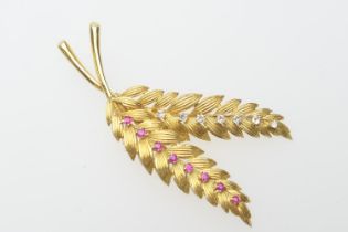 Yellow gold, diamond and ruby twin leaf brooch, set with seven small round cut diamonds and eight