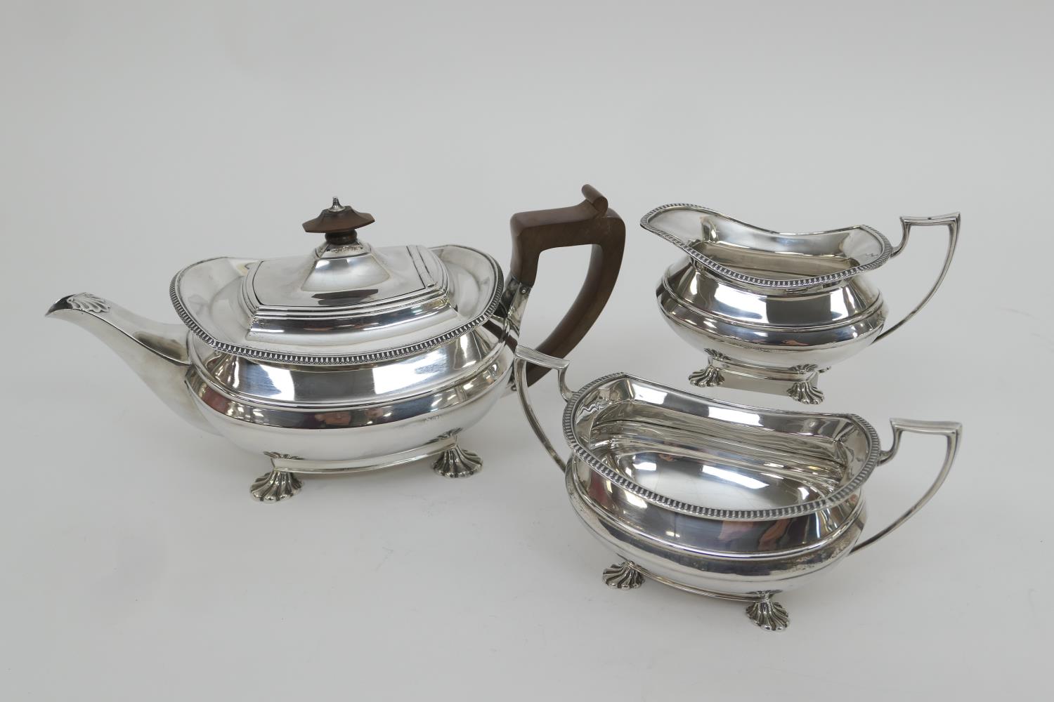 George VI silver three piece tea service, maker GH, Sheffield 1937, comprising teapot of bombe