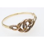 9ct gold hinged bangle, formed as an openwork knot, with a textured finish, cuff size 57mm, weight