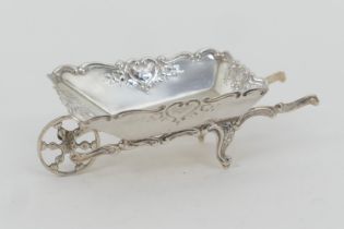 Continental white metal novelty sweetmeat dish, formed as a wheelbarrow, solid sides with repousse