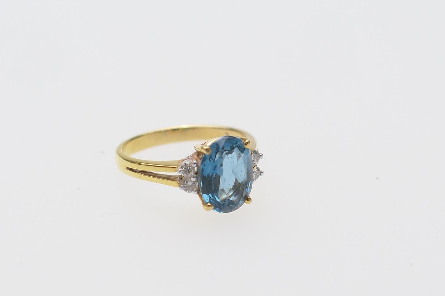 Diamond and blue zircon dress ring, the central oval cut stone of approx. 3cts, bordered with four