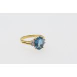 Diamond and blue zircon dress ring, the central oval cut stone of approx. 3cts, bordered with four