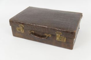 Crocodile skin suitcase by Reid & Todd Ltd, Glasgow, with brass locks, brown satin lined interior,
