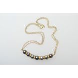 Black pearl and diamond choker necklace, in 18ct yellow gold, set with seven grey coloured pearls,