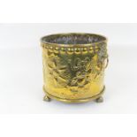 Dutch brass coal bin, with lion's mask ring handles, decorated with flowerhead roundels and fruit,