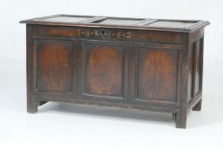 Charles II oak joined coffer, dated 1662, the three recessed panel top over a front carved with '