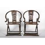 A pair of articulated chairs with footrest