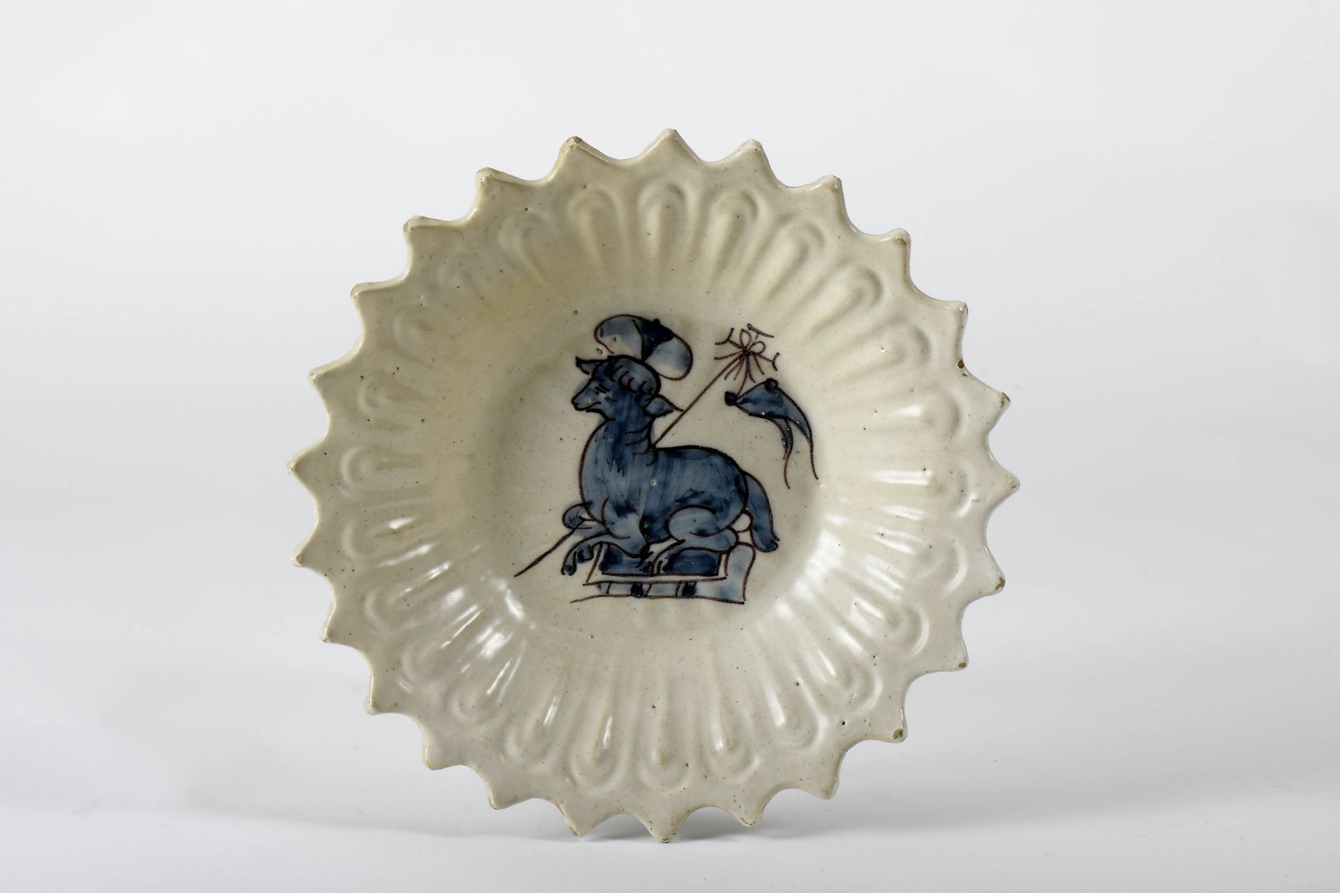 A scalloped cup with foot