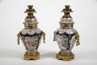 A pair of pots with covers