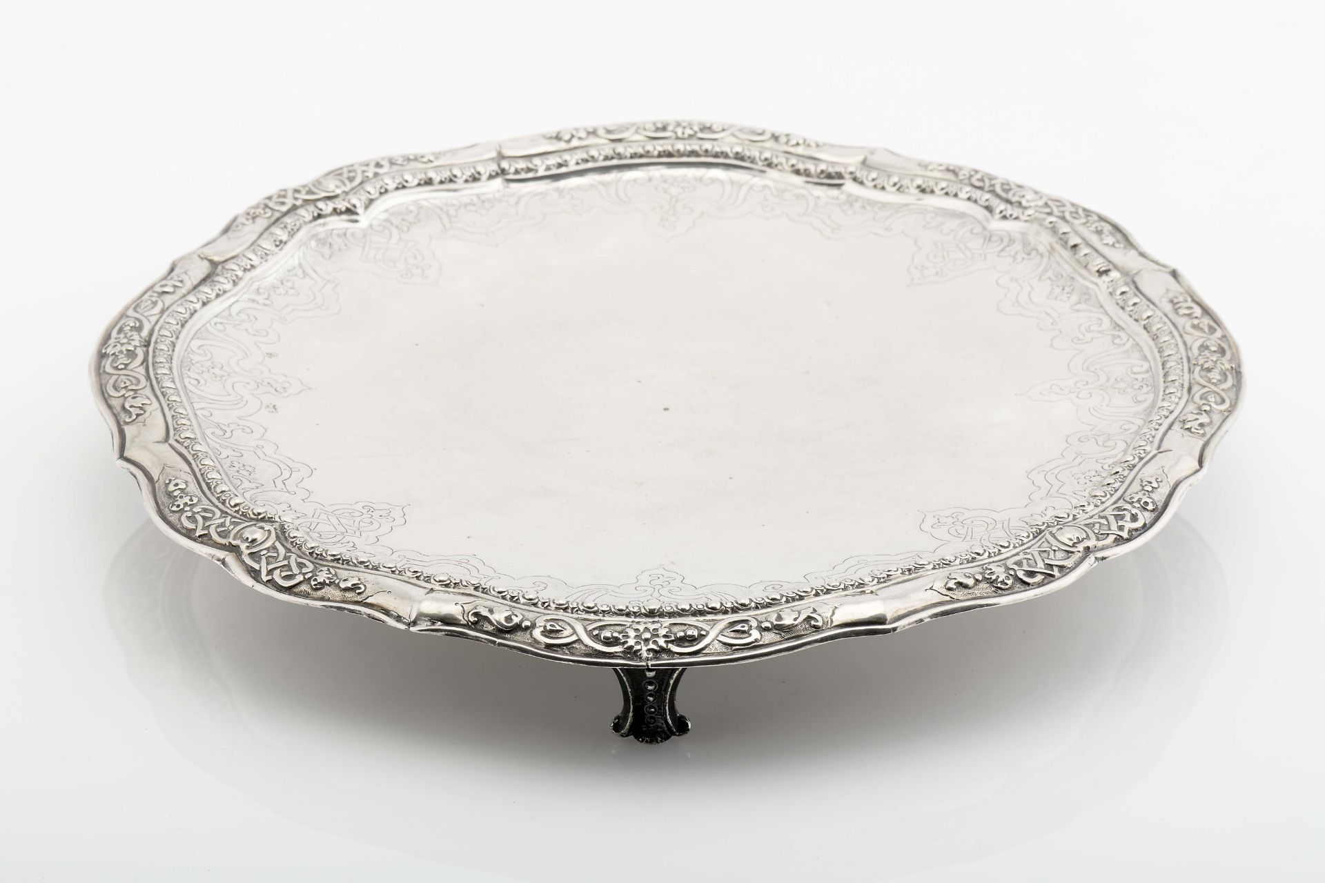 A scalloped three-footed salver (card tray top)