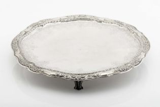 A scalloped three-footed salver (card tray top)