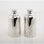A pair of bottles with covers