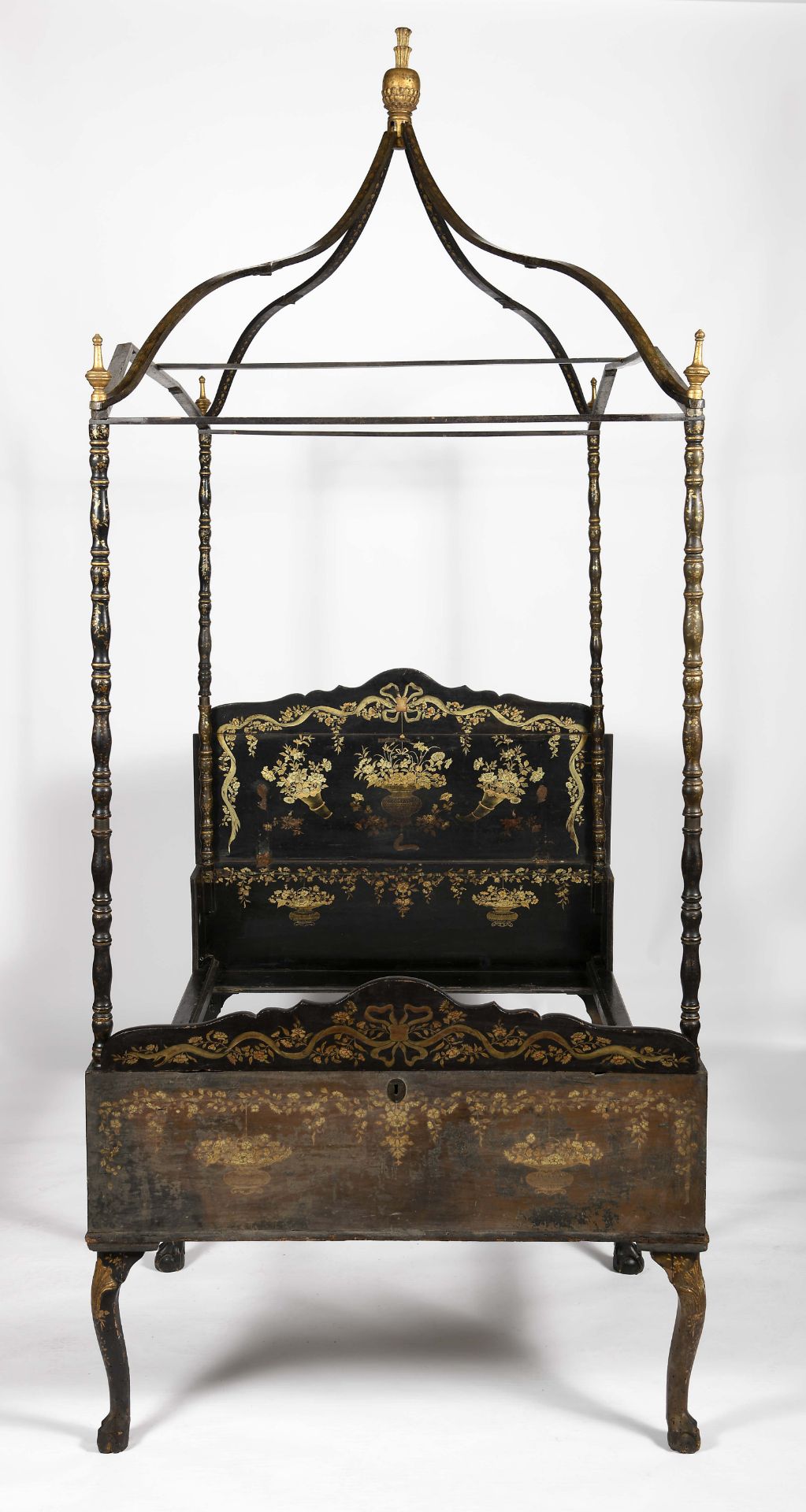 A chest convertible into a four-poster field bed