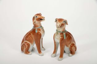 A pair of sitting dogs