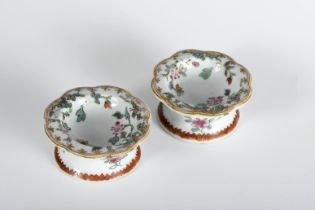 A pair of round scalloped salt cellars with low stem