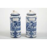 A pair of pharmacy jars with covers