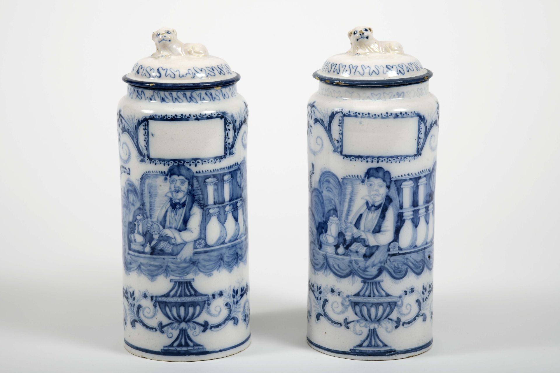 A pair of pharmacy jars with covers
