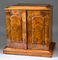 An Early 19th Century Walnut Miniature Cabinet, with moulded edge to top, fitted three small drawers