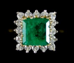 An Emerald and Diamond Ring, set with a centre emerald, approximately 3ct, surrounded by small