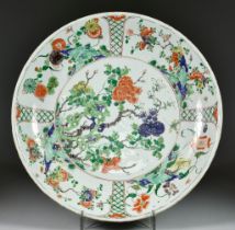 A Chinese Kangxi Famille Verte Porcelain Charger, enamelled with rockwork and flowering branches,