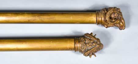 A Pair of 20th Century Gilt Reeded Curtain Poles, with rams head finials, 71ins wide overall, and