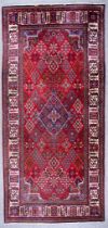 A 20th Century Joshaghan Carpet, woven in colours of ivory, navy blue and wine, with a central