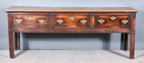 An 18th Century Oak Dresser Base, with plain two plank top, and moulded edge, fitted three frieze