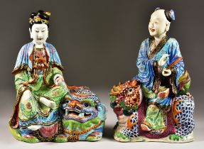 Two Chinese Famille Rose Porcelain Models of Figures Seated on Lion Dogs, Late 19th/Early 20th