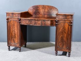 A Late George III Figured Mahogany Bow and Break Front Pedestal Sideboard, with arched back, the
