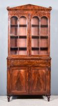 A William IV Figured Mahogany Bookcase, the upper part with architectural cornice, plain frieze,