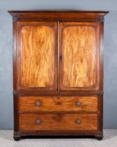 A George IV Gentleman's Mahogany Wardrobe, the whole decorated with reeded uprights and frieze