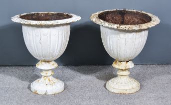 A Pair of White Painted Cast Iron Garden Urns, Early 20th Century, on circular bases, 18ins diameter