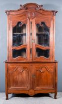 A 19th Century French Provincial Oak Bookcase, with scroll carved cornice, the frieze decorated with