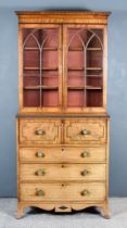 A George IV Figured Mahogany Secretaire Bookcase, the upper part with moulded cornice, fitted