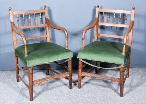 A Pair of Early 20th Century Oak Armchairs, with spindle turned backs, seats upholstered in green