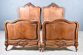 A Pair of Late 19th Century French Mahogany 3ft 6ins Bedsteads, the head and foot boards with leaf